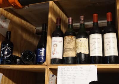 Bottles on a shelf in Le Chene's Wine Cellar
